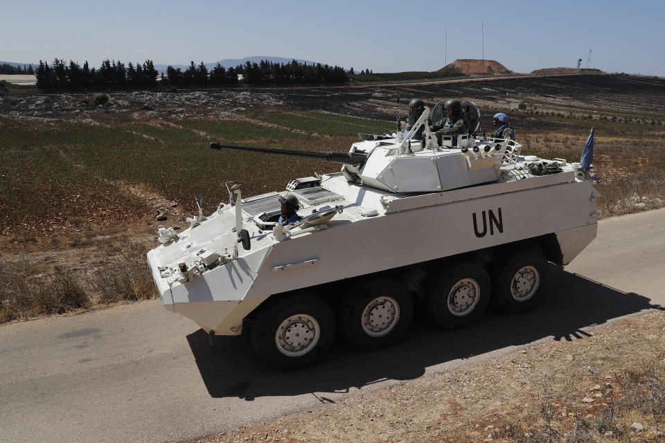 Irish UN peacekeepers use an armored patrol vehicle patrol near the fields struck by Israeli army shells in the southern Lebanese-Israeli border village of Maroun el-Ras, Lebanon, Monday, Sept. 2, 2019. The Lebanon-Israel border was mostly calm with U.N. peacekeepers patrolling the border Monday, a day after the Lebanese militant Hezbollah group fired a barrage of anti-tank missiles into Israel, triggering Israeli artillery fire that lasted less than two hours and caused some fires. (AP Photo/Hussein Malla)