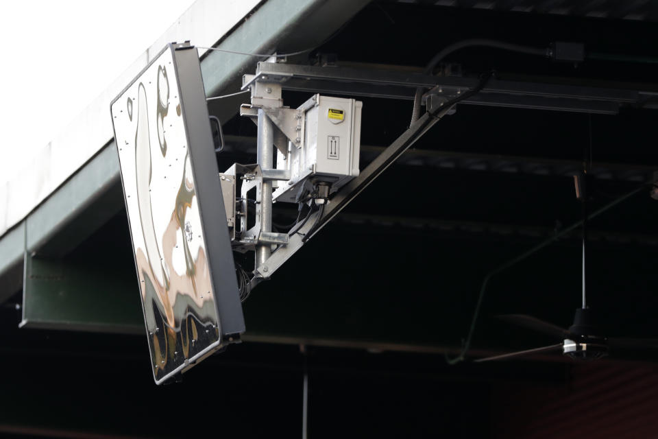 A radar device is seen on the roof behind home plate at PeoplesBank Park during the third inning of the Atlantic League All-Star minor league baseball game, Wednesday, July 10, 2019, in York, Pa. Home plate umpire Brian deBrauwere wore the earpiece connected to an iPhone in his ball bag which relayed ball and strike calls upon receiving it from a TrackMan computer system that uses Doppler radar. The independent Atlantic League became the first American professional baseball league to let the computer call balls and strikes during the all star game. (AP Photo/Julio Cortez)