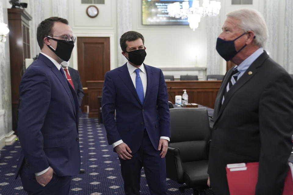 Transportation Secretary nominee Pete Buttigieg talks with Sen. Roger Wicker, R-Miss., right, and his husband Chasten Buttigieg, left, as they arrive for a confirmation hearing before the Senate Commerce, Science and Transportation Committee on Capitol Hill, Thursday, Jan. 21, 2021, in Washington. (Stefani Reynolds/Pool via AP)