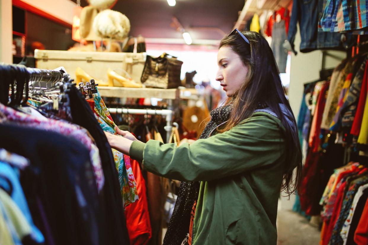 Beautiful woman shopping in second hand marketplace