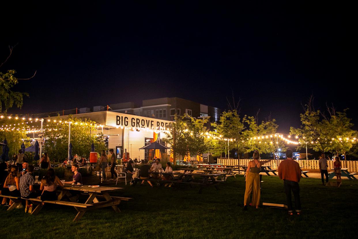 People play games on the lawn Tuesday at Big Grove Brewery & Taproom in Iowa City. The plan for the Des Moines location also calls for a spacious outdoor area.