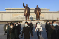 Pyongyang citizens visit Mansu Hill to pay respect to the statues of their late leaders Kim Il Sung and Kim Jong Il on the occasion of the 75th founding anniversary of the Korean People's Army in Pyongyang, North Korea Wednesday, Feb. 8, 2023. (AP Photo/Jon Chol Jin)