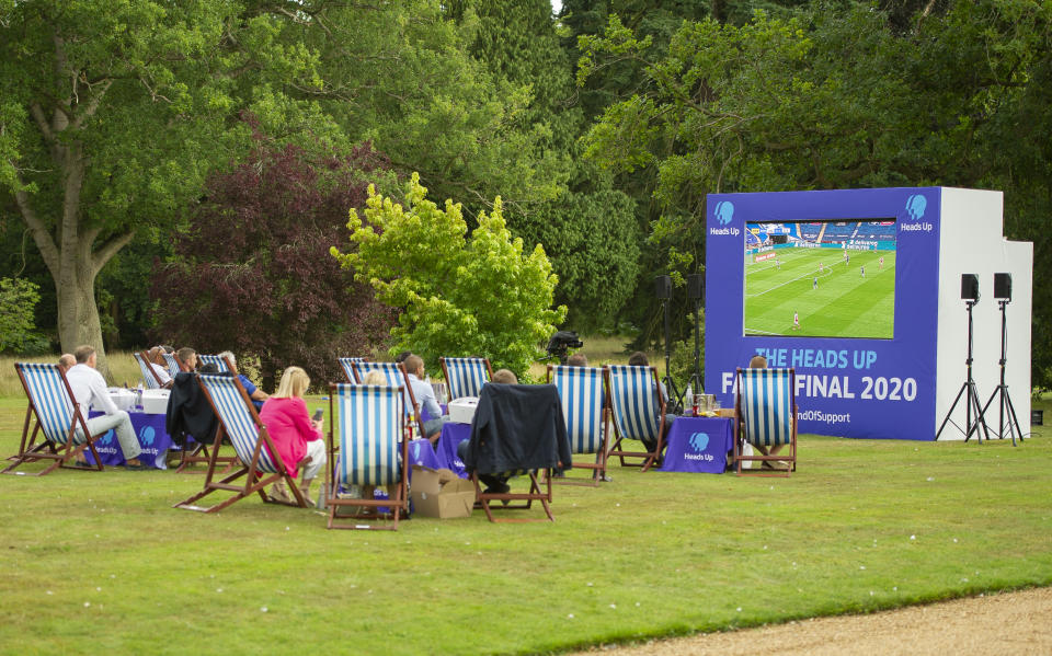 KING'S LYNN, ENGLAND - AUGUST 01: People watch the match as Prince William, Duke of Cambridge hosts an outdoor screening of the Heads Up FA Cup final on the Sandringham Estate on August 1, 2020 in King's Lynn, England. (Photo by Tim Merry - WPA Pool/Getty Images)