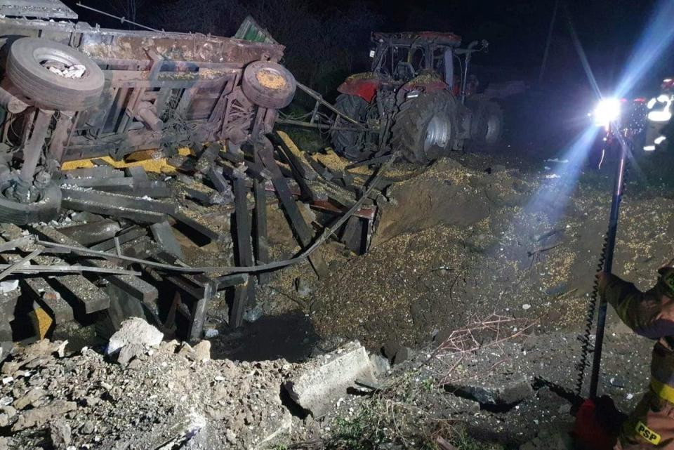 A damaged vehicle lies next to a crater formed at the site of an explosion in Przewodow (via REUTERS)