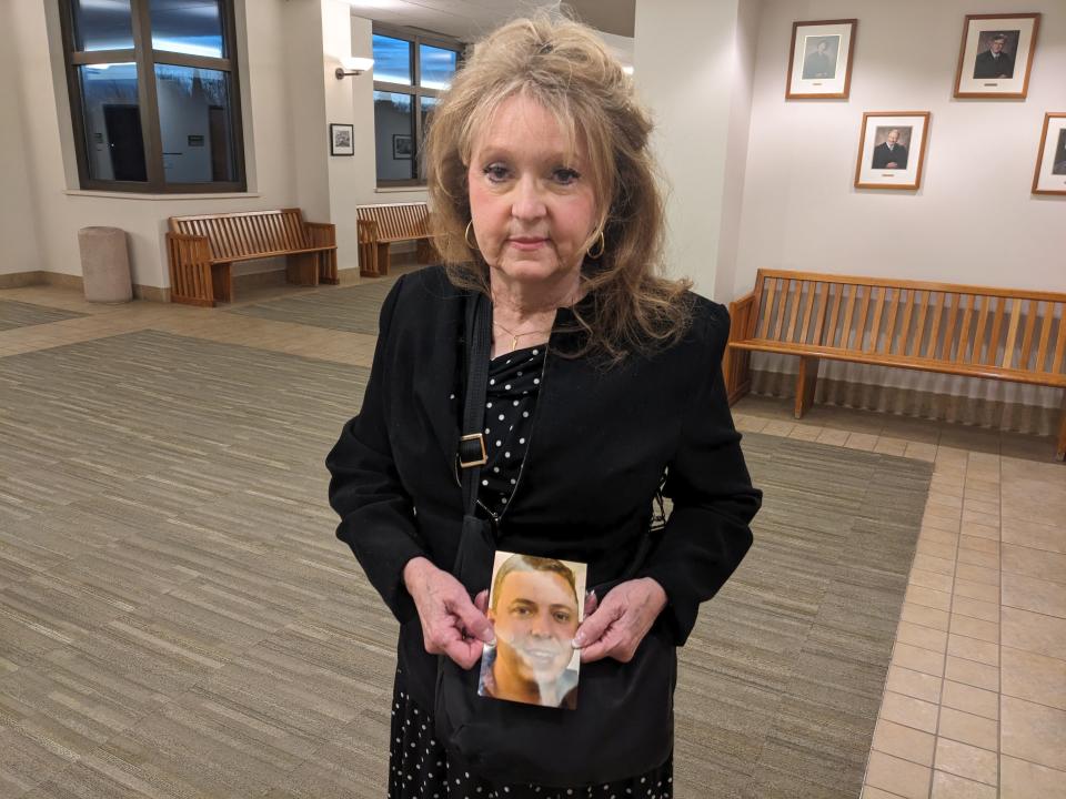 Patricia Telleen holds a photo of her son, Jason Telleen, outside a court room in the Larimer County Justice Center Monday. Jason was run over and killed by a Transfort bus in in January while working in the transit maintenance facility.