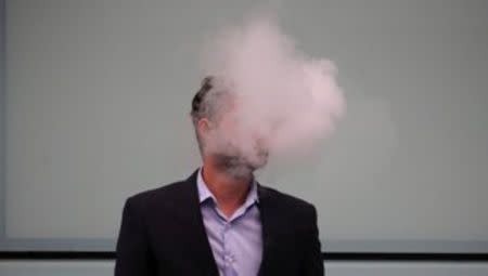 A man vapes outside Southwark Crown Court in London, Britain, September 25, 2017. REUTERS/Hannah McKay