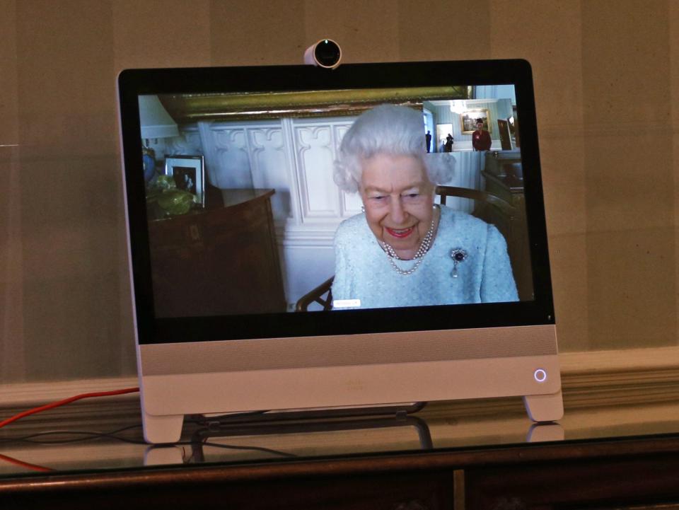 Queen Elizabeth II appears on a screen by videolink from Windsor Castle (PA)