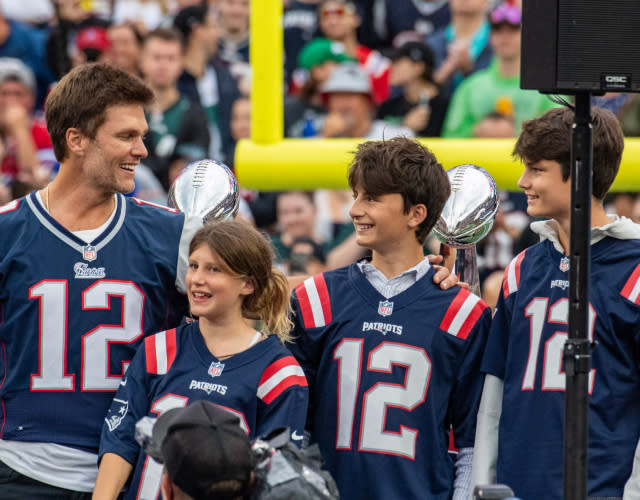 Tom Brady (L) stands with his children during a “Thank You” celebration honoring the former New England Patriots’ quarterback during halftime of the home opening game for the New England Patriots on September 10, 2023 in Foxborough, Massachusetts. <em>Photo by JOSEPH PREZIOSO/AFP via Getty Images.</em>