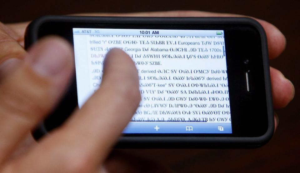 While translation apps are an an exciting development, they are limited to literal translations. Here Joseph Erb demonstrates a smartphone with the Cherokee language at the Cherokee Nation Immersion School in Tahlequah, Okla. (AP/Sue Ogrocki)