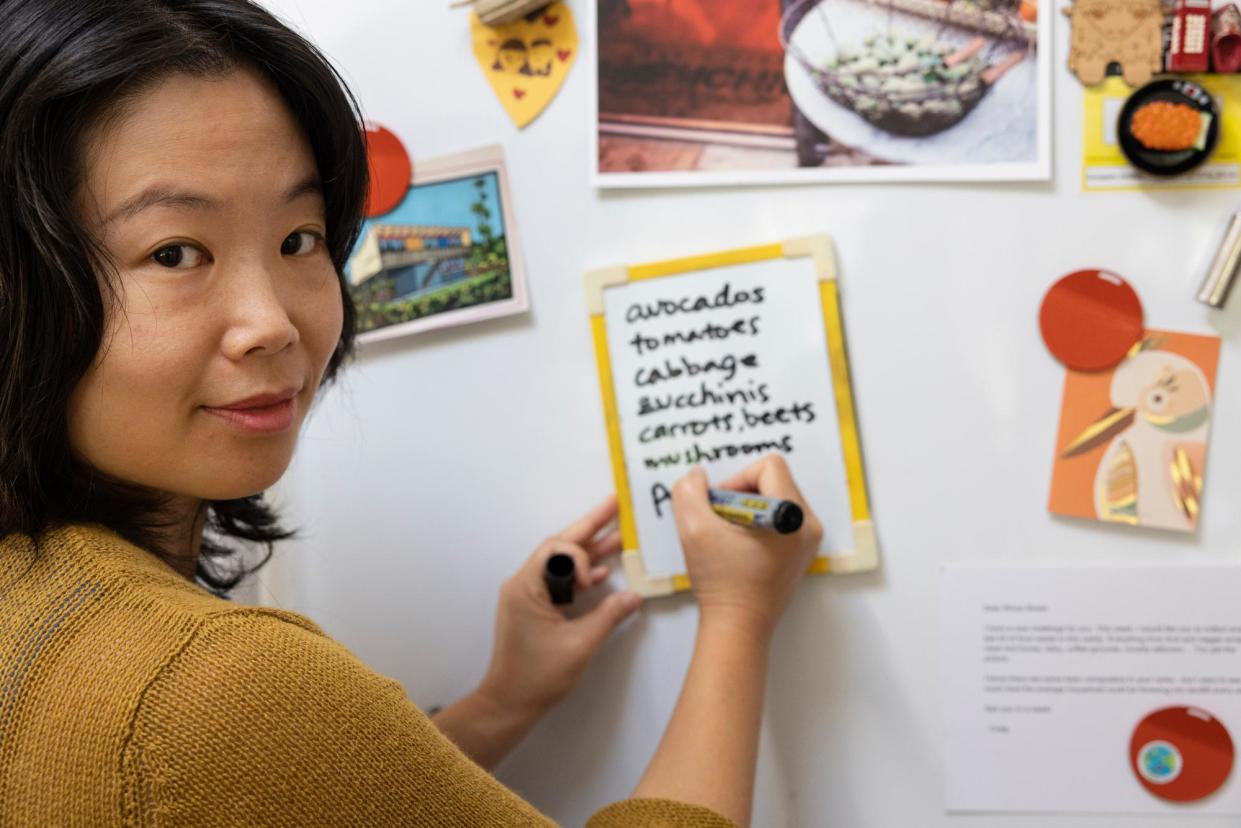 <span>Lucy Leonardi lists all the vegetables in her fridge on its door for quick reference to help ensure they are used.</span><span>Photograph: Jessica Hromas/The Guardian</span>