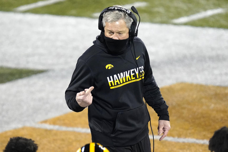 Iowa head coach Kirk Ferentz talks to his players during the second half of an NCAA college football game against Illinois Saturday, Dec. 5, 2020, in Champaign , Ill. Iowa won 35-21. (AP Photo/Charles Rex Arbogast)