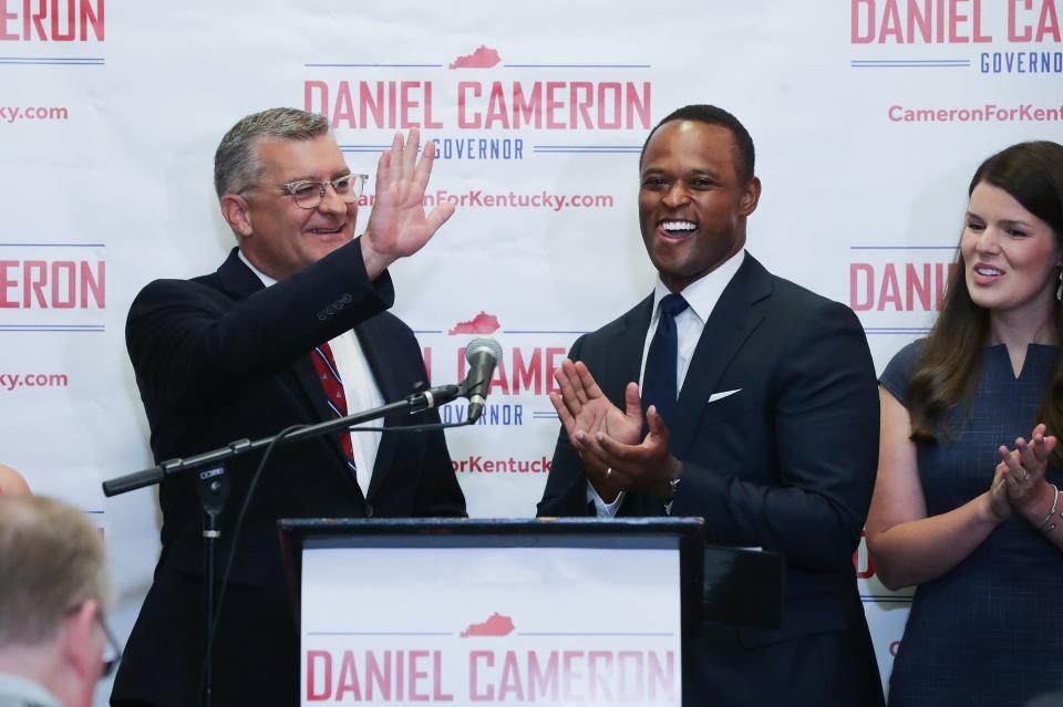 Kentucky Attorney General and Republican candidate for governor Daniel Cameron, center, introduced his running mate Robby Mills, left, as Cameron's wife Makenze Cameron looked on during the announcement at the Republican Party headquarters in Frankfort, Ky. on July 19, 2023.