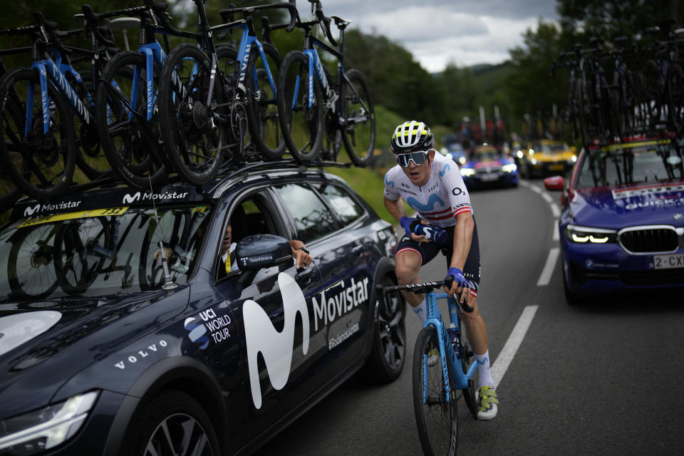 Austria's Gregor Muehlberger gets water bottles from his team car during the fifth stage of the Tour de France cycling race over 163 kilometers (101 miles) with start in Pau and finish in Laruns, France, Wednesday, July 5, 2023. (AP Photo/Daniel Cole)