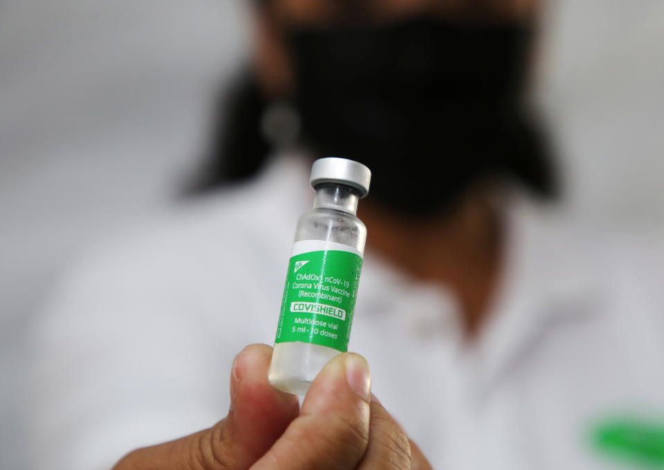 A health worker holds a vial with doses of the Oxford-AstraZeneca vaccine, marketed by the Serum Institute of India as Covishield. Photo: Ranu Abhelakh