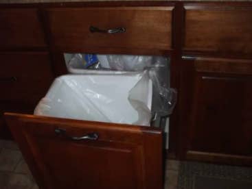 Wood paneled trash drawer 