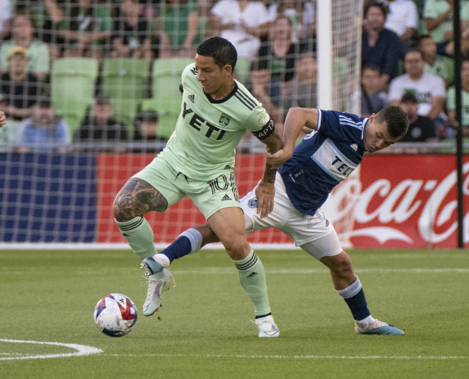 Austin FC midfielder Sebastian Driussi, left, vies for the ball against Vancouver Whitecaps midfielder Andres Cubas during the first half of an MLS soccer match Saturday, April 15, 2023, in Austin, Texas. (AP Photo/Michael Thomas)