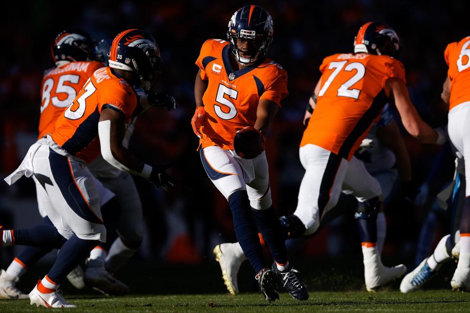 Denver Broncos quarterback Teddy Bridgewater (5) hands the ball off to running back Javonte Williams (33) in the first quarter against the Detroit Lions at Empower Field at Mile High on Dec. 12, 2021.