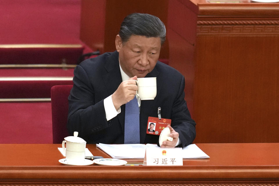 Chinese President Xi Jinping drinks from a cup during the second plenary session meeting of the National People's Congress (NPC) in the Great Hall of the People in Beijing, China, Friday, March 8, 2024. (AP Photo/Tatan Syuflana)