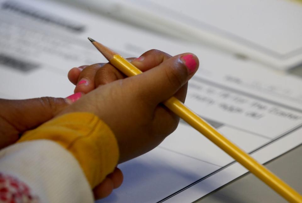 A student prepares to do work at Gulf Avenue Elementary School in Wilmington.