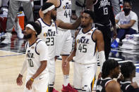 Utah Jazz forward Royce O'Neale, center, pats guard Donovan Mitchell, right, on the head as guard Mike Conley walks away in the closing minutes during the second half in Game 6 of a second-round NBA basketball playoff series against the Los Angeles Clippers Friday, June 18, 2021, in Los Angeles. (AP Photo/Mark J. Terrill)