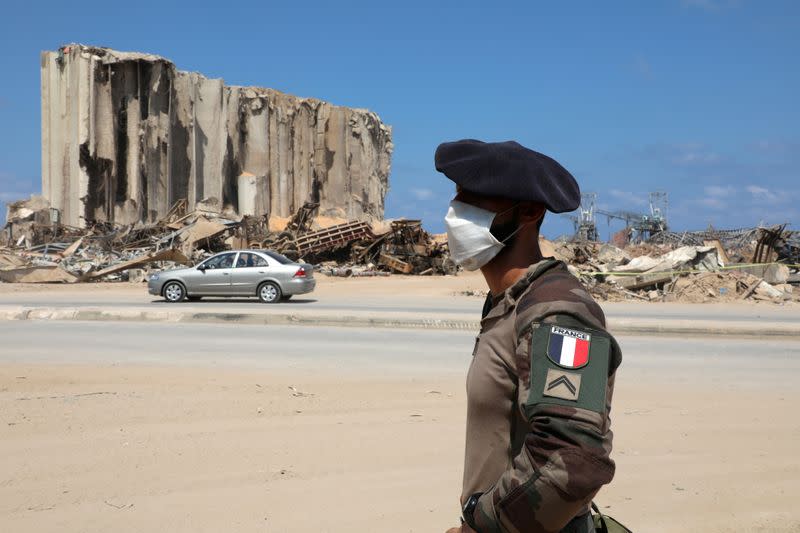 A member of the French military wears a face mask as he stands near the damaged grain silos during a joint effort with the Lebanese army to clear rubble from the port of Beirut following the explosion