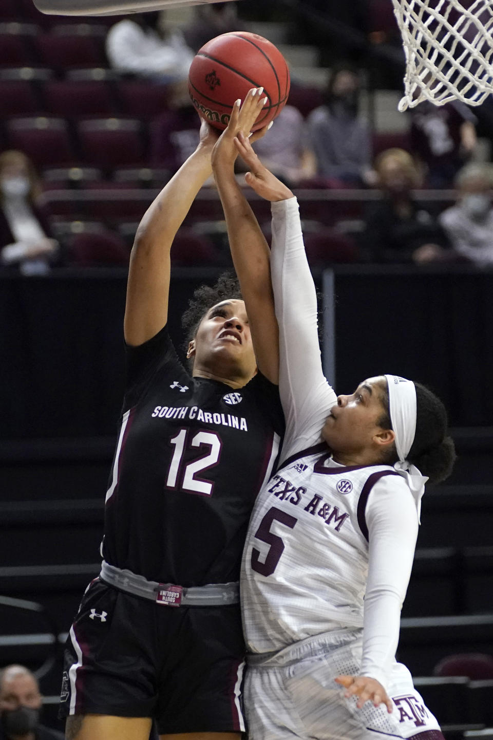 South Carolina guard Brea Beal (12) shoots over Texas A&M guard Jordan Nixon (5) during the first half of an NCAA college basketball game Sunday, Feb. 28, 2021, in College Station, Texas. (AP Photo/Sam Craft)