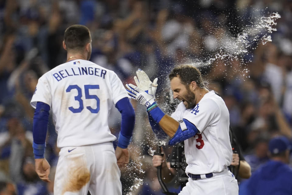 Los Angeles Dodgers' Chris Taylor (3) celebrates with Cody Bellinger (35) after they both scored off of a home run hit by Taylor during the ninth inning to win a National League Wild Card playoff baseball game 3-1 over the St. Louis Cardinals, Wednesday, Oct. 6, 2021, in Los Angeles. (AP Photo/Marcio Jose Sanchez)