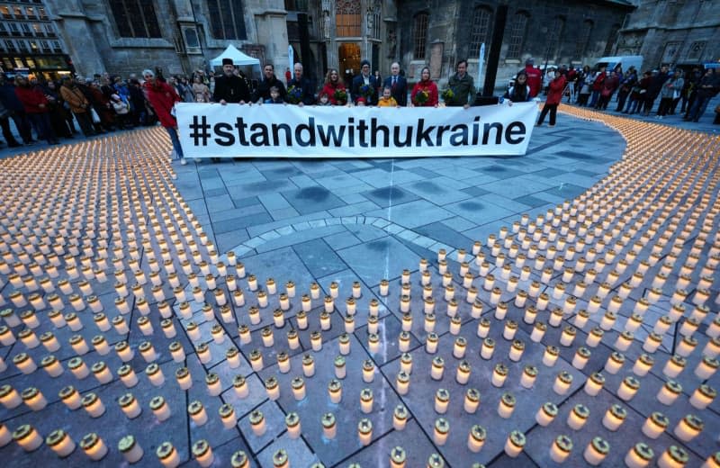 Candles are placed at the event "728 days of war" organized by Caritas of the Archdiocese of Vienna to commemorate the second anniversary of Russia's invasion of Ukraine. Georg Hochmuth/APA/dpa