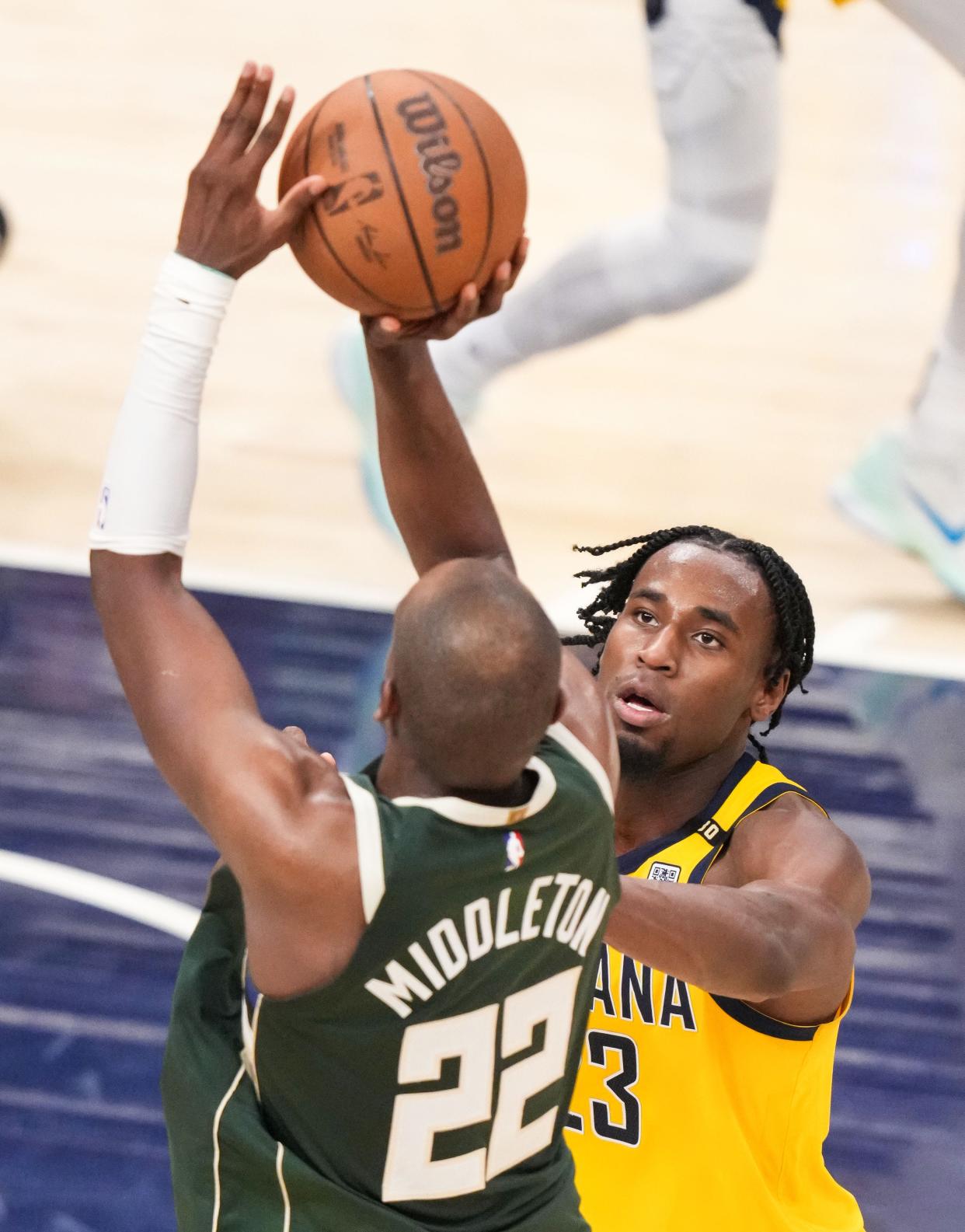 Indiana Pacers forward Aaron Nesmith (23) attempts to guard Milwaukee Bucks forward Khris Middleton (22) on Friday, April 26, 2024, during the game at Gainbridge Fieldhouse in Indianapolis. The Indiana Pacers defeated the Milwaukee Bucks in overtime, 121-118.