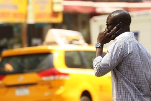 A man speaks on his mobile phone in New York City. Mobile phone users may be at increased risk from brain cancer and should use texting and free-hands devices to reduce exposure, the World Health Organisation's cancer experts said Tuesday