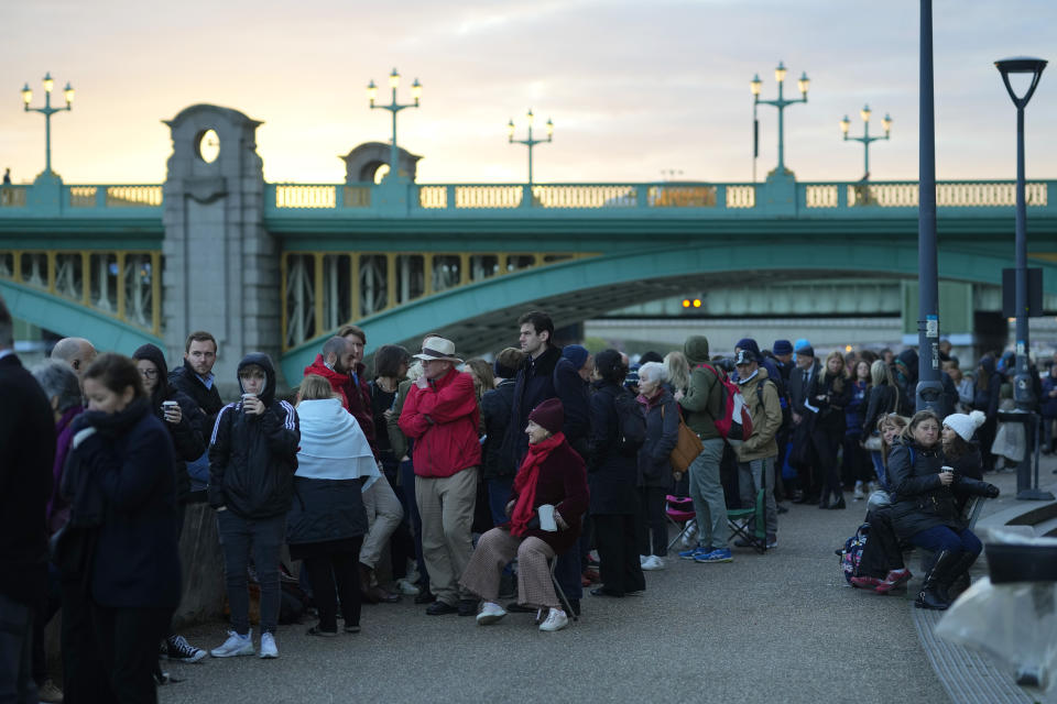 People wait in a queue to pay their respect to the late Queen Elizabeth II during the Lying-in State, in Westminster Hall, London, England, Friday, Sept. 16, 2022. The Queen will lie in state in Westminster Hall for four full days before her funeral on Monday Sept. 19. (AP Photo/Petr David Josek)