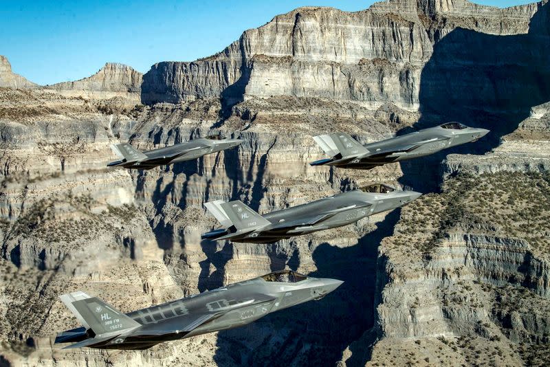 FILE PHOTO: A formation of U.S. Air Force F-35 Lightning II fighter jets perform aerial maneuvers during as part of a combat power exercise