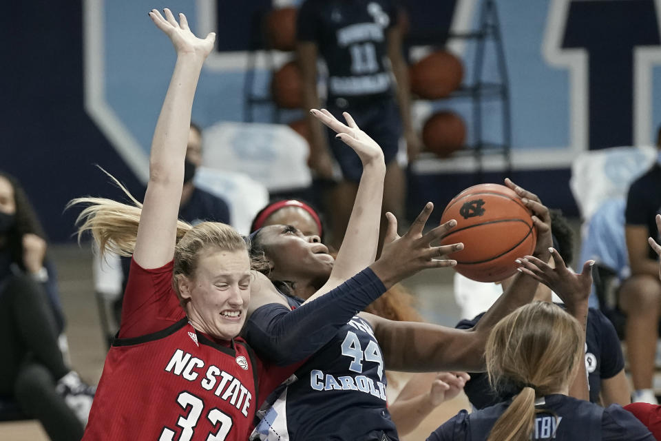 North Carolina State center Elissa Cunane (33) and North Carolina center Janelle Bailey (44) struggle for possession of the ball during the second half of an NCAA college basketball game in Chapel Hill, N.C., Sunday, Feb. 7, 2021. (AP Photo/Gerry Broome)