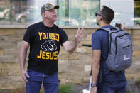 A man, who identified himself as J. K. of Atlanta, left, argues a point outside the annual Southern Baptist Convention meeting Monday, June 14, 2021, in Nashville, Tenn. A number of people demonstrated against the denomination's practices outside the venue. (AP Photo/Mark Humphrey)