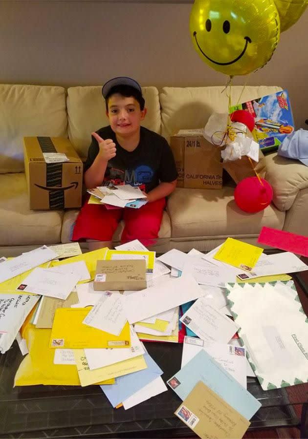 Christopher is pictured sitting amongst his thousands of letters. Photo: Facebook.