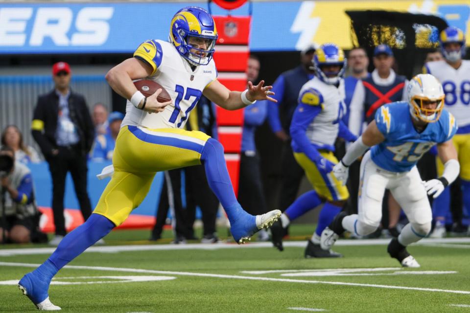 Rams quarterback Baker Mayfield scrambles against the Chargers on Jan. 1.