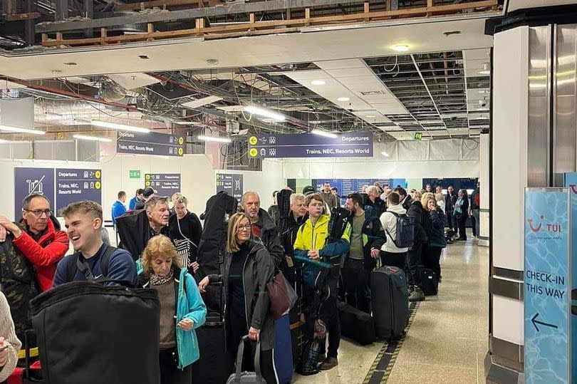 Photo shows long queue at Birmingham Airport