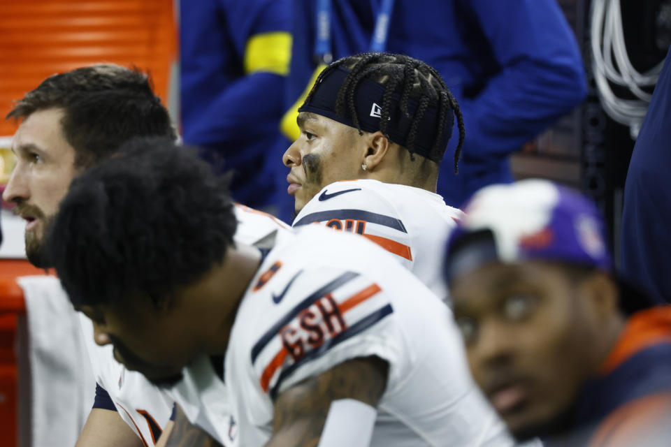 Chicago Bears quarterback Justin Fields, center, sits on the bench during the second half of an NFL football game against the Detroit Lions, Sunday, Jan. 1, 2023, in Detroit. (AP Photo/Duane Burleson)