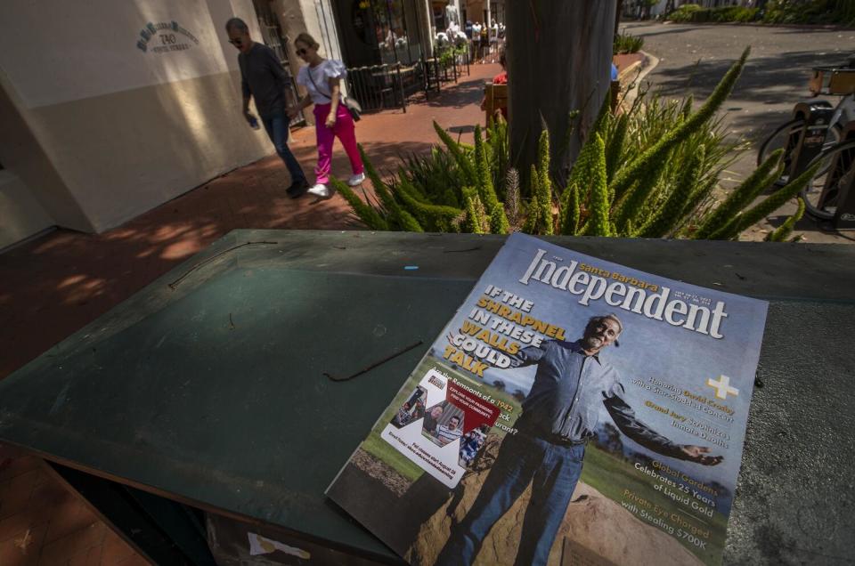 People walk along State Street in Santa Barbara