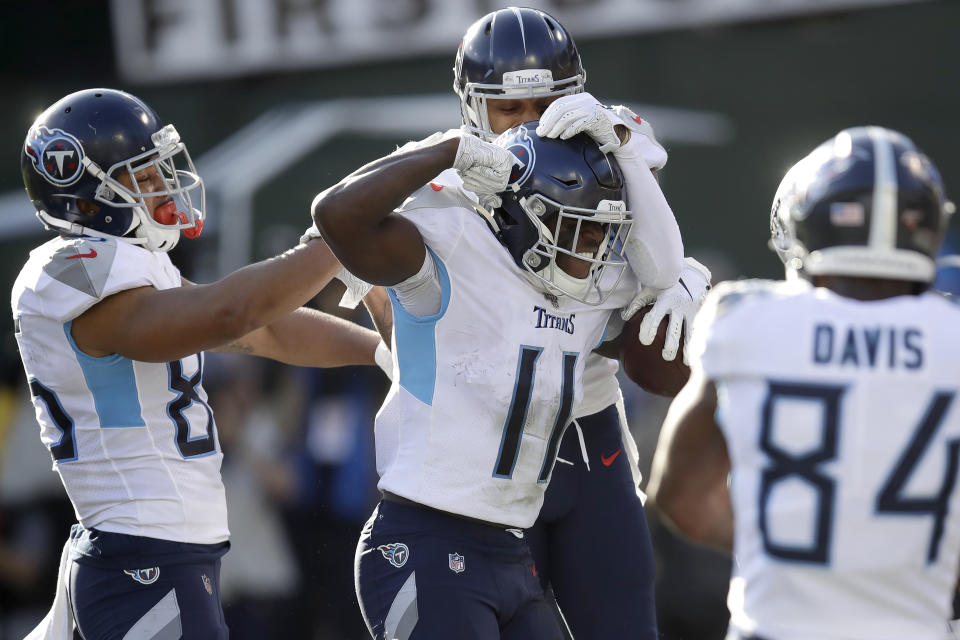 Tennessee Titans wide receiver A.J. Brown (11) is congratulated by teammates after scoring against the Oakland Raiders during the first half of an NFL football game in Oakland, Calif., Sunday, Dec. 8, 2019. (AP Photo/Ben Margot)