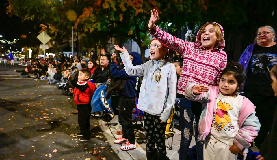 Spectators react to Santa Claus during the annual Candy Cane Lane Parade in Downtown Visalia on Monday, November 28, 2022. 