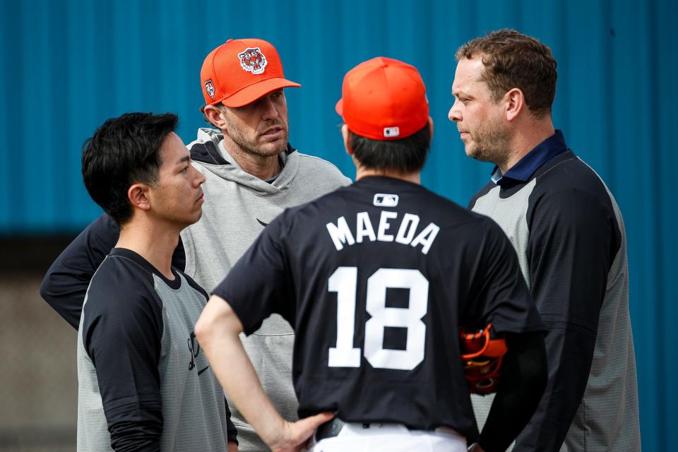 Detroit Tigers pitcher Kenta Maeda and interpreter Dai Sekizaki, left, talk to pitching coach Chris Fetter, center, and major league video coordinator Austin Tripp, right, during spring training at Tigertown in Lakeland, Fla. on Thursday, Feb. 15, 2024.