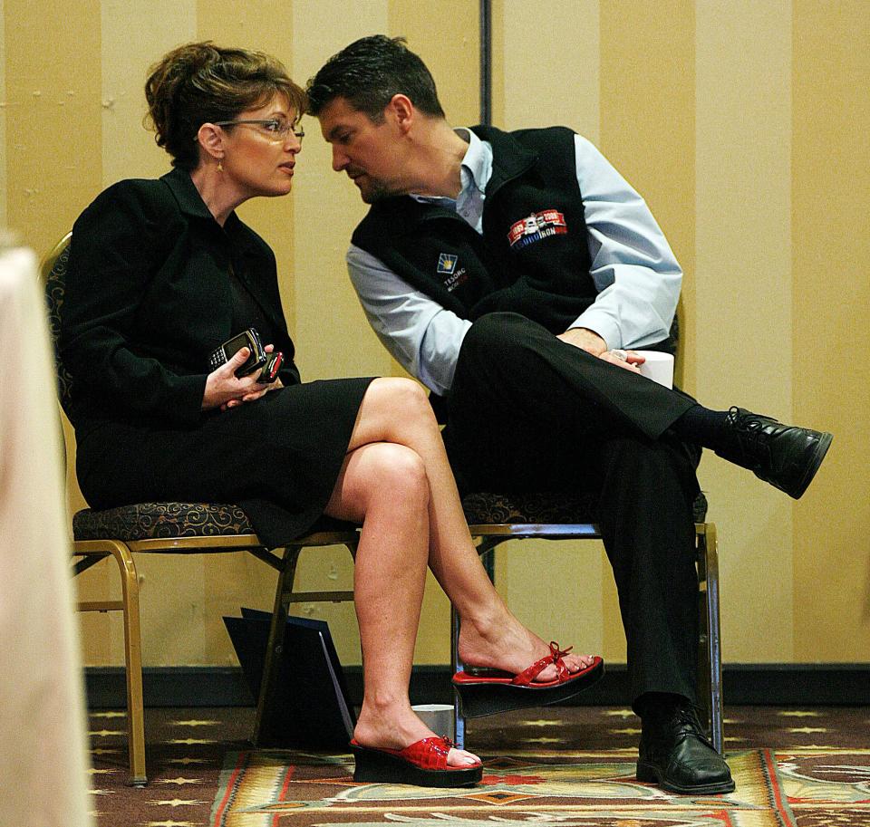 From left: Sarah and Todd Palin listen to the state's revenue commissioner in Anchorage, Alaska.