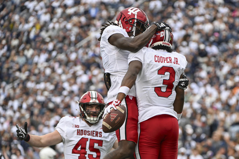 Indiana wide receiver Omar Cooper Jr. (3) celebrates a touchdown with Andison Coby (0) during the second half of an NCAA college football game against Penn State, Saturday, Oct. 28, 2023, in State College, Pa. (AP Photo/Barry Reeger)