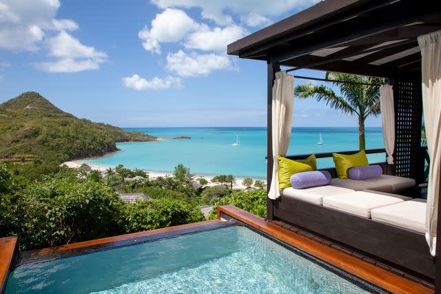 <p>Courtesy of Hermitage Bay</p> A day bed and private plunge pool at Hermitage Bay Antigua.