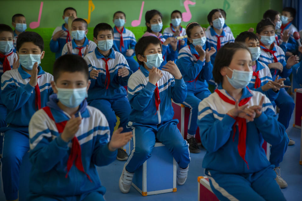 Schoolchildren dance during a music class at a primary school, as seen during a government-organized visit for foreign journalists, in Awati Township in Kashgar in western China's Xinjiang Uyghur Autonomous Region, Monday, April 19, 2021. Xinjiang in far western China had the sharpest known decline in birthrates between 2017 and 2019 of any territory in recent history, according to a new analysis by an Australian think tank. (AP Photo/Mark Schiefelbein)