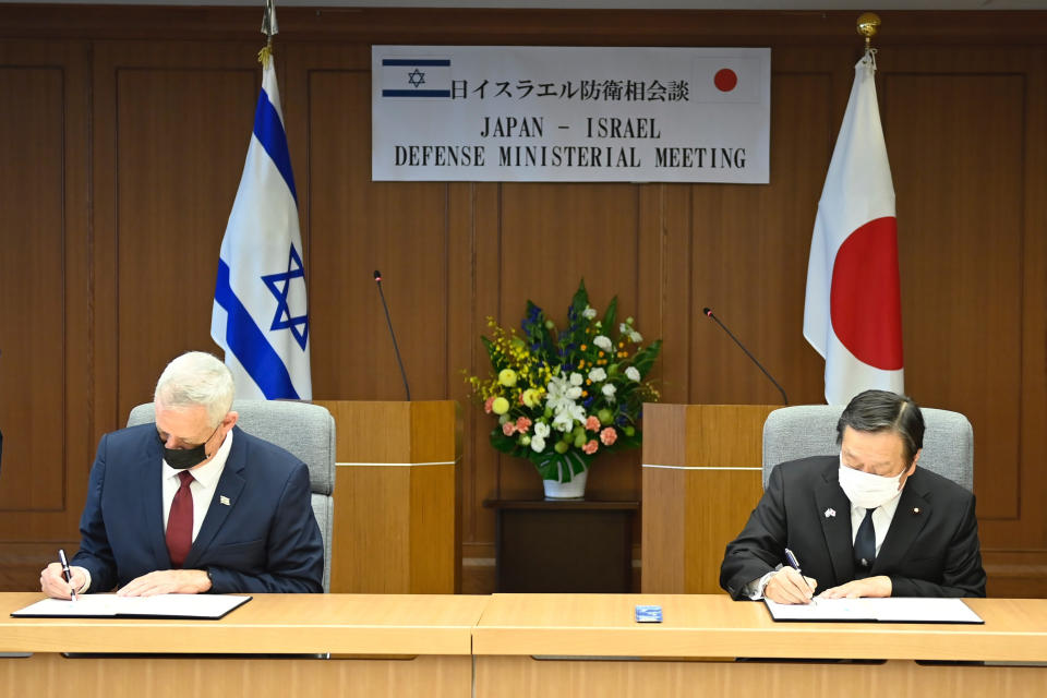 Israeli Defense Minister Benny Gantz, left, and Japan's Defense Minister Yasukazu Hamada attend a signing of Japan-Israel defense exchange memorandum of understanding after their bilateral meeting at the Defense Ministry in Tokyo Tuesday, Aug. 30, 2022. (David Mareuil/Pool Photo via AP)