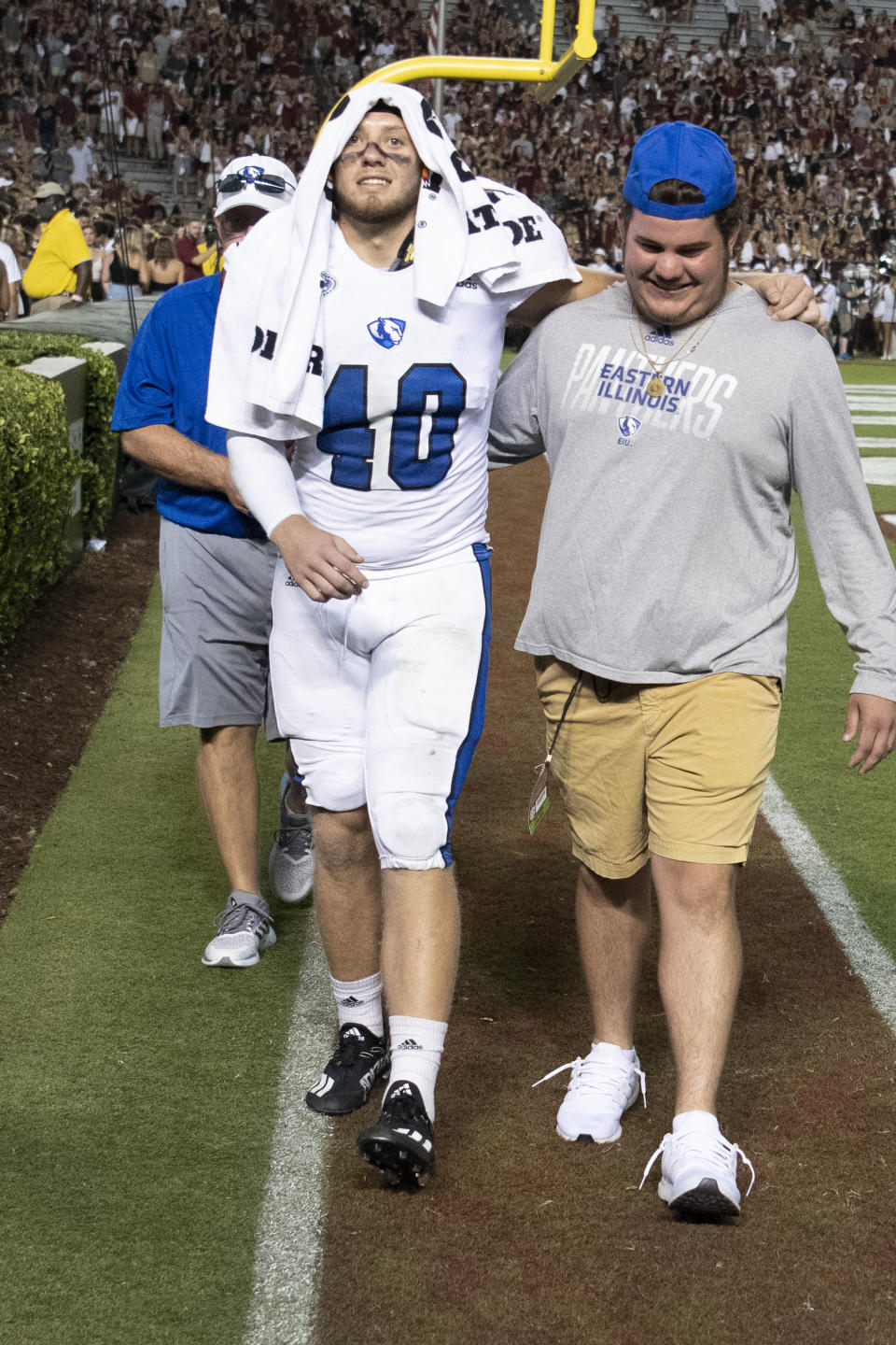 Eastern Illinois linebacker Phoenix Porter (40) is helped to the locker room during the first half of an NCAA college football game against South Carolina, Saturday, Sept. 4, 2021, in Columbia, S.C. (AP Photo/Hakim Wright Sr.)