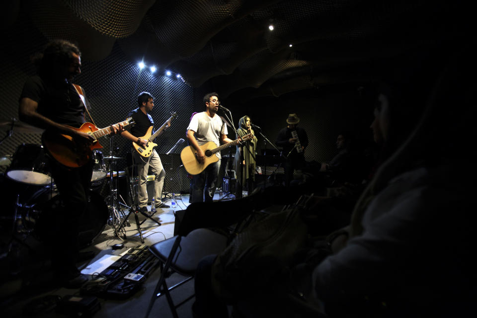 In this picture taken on Friday, Jan. 25, 2013, members of an Iranian band called "Accolade" perform in an unauthorized stage performance in Tehran, Iran. Heavy metal guitarists jamming in basements. Headphone-wearing disc jockeys mixing beats. Its an underground music scene that is flourishing in Iran, despite government restrictions. (AP Photo/Vahid Salemi)