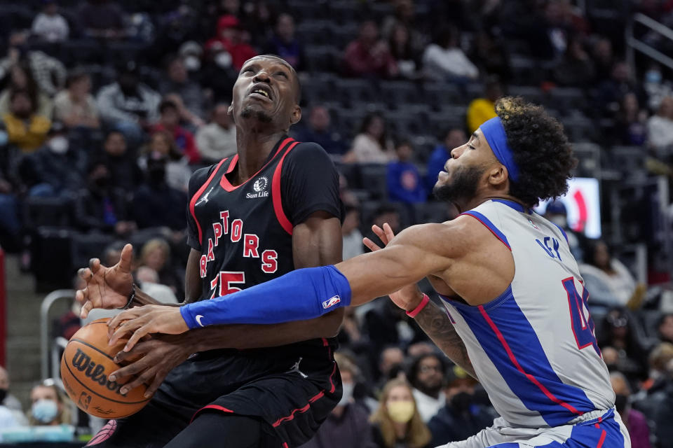 Detroit Pistons forward Saddiq Bey (41) knocks the ball away from Toronto Raptors forward Chris Boucher during the second half of an NBA basketball game, Friday, Jan. 14, 2022, in Detroit. (AP Photo/Carlos Osorio)